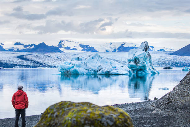 istock Lonely man is looking at a iceberg 1043782060