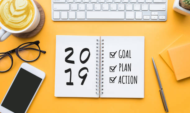 istock 2019 new year goal,plan,action text on notepad with office accessories.Business motivation,inspiration 1043782588