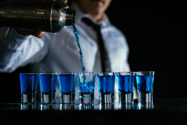 istock Pouring blue cocktail shots 1043785680