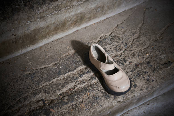 istock Abandoned baby shoe lying on old concrete floor 1043787442