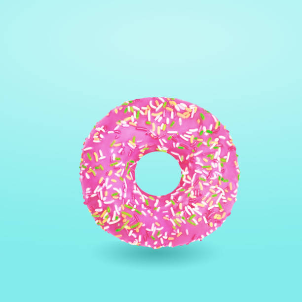 istock Pink donut with icing on blue background 1043787448