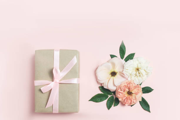 istock Gift box with roses on pink bacground. 1043787518