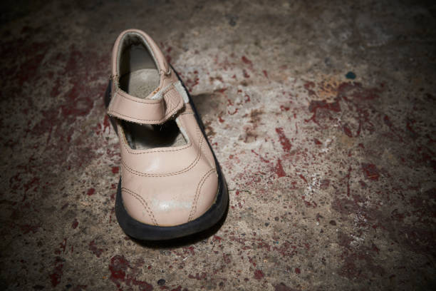 istock Abandoned baby shoe lying on old concrete floor 1043787522