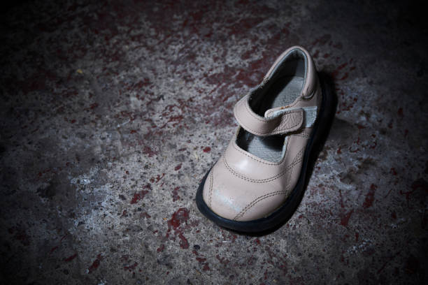 istock Abandoned baby shoe lying on old concrete floor 1043787538