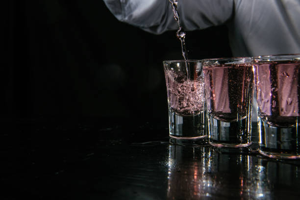 istock Barman pouring shots in cocktail bar 1043792062