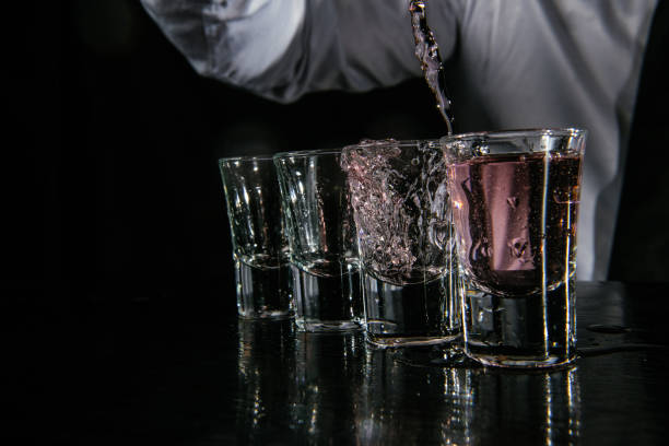 istock Barman pouring shots in cocktail bar 1043792194