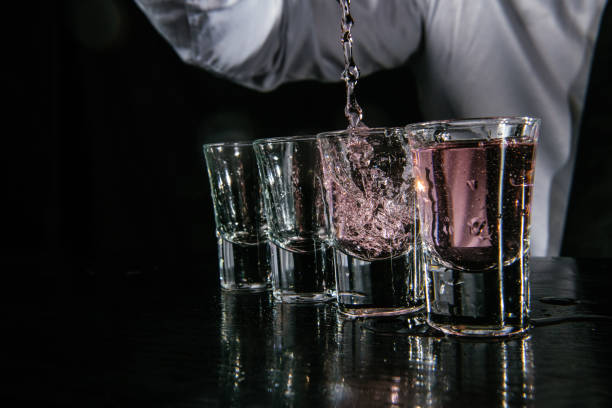 istock Barman pouring shots in cocktail bar 1043792336
