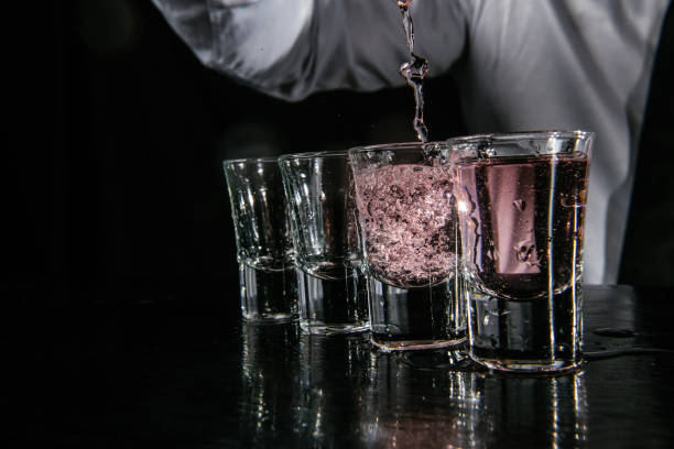 istock Barman pouring shots in cocktail bar 1043792472