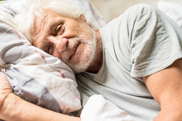 istock Senior man in bed in the morning 1043792716