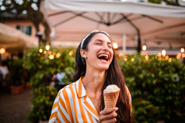 istock Laughing woman eating ice cream. 1043793138