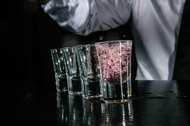istock Barman pouring shots in cocktail bar 1043793250