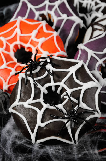 istock Glazed donuts decorated with cobwebs for Halloween 1043801414