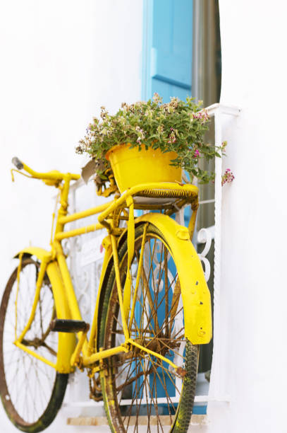 Yellow bicycle at the window on the Greek island.