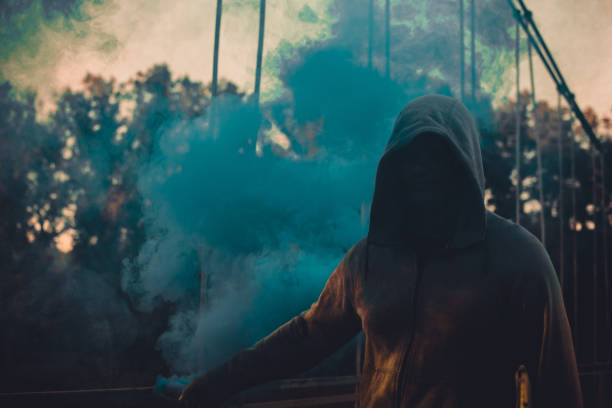 istock Young Man Rebel With Smoke Bomb In His Hand 1043815664