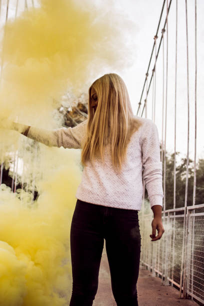 istock Young woman holding a smoke bomb 1043815844