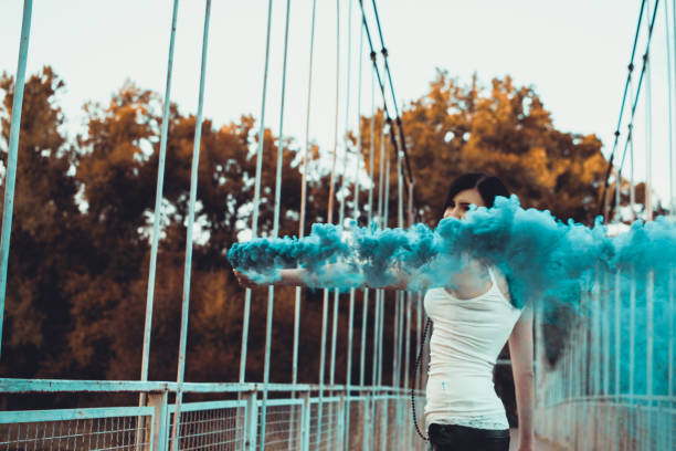 istock Beautiful girl with colored smoke bomb 1043815922