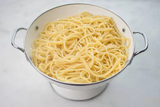 Cooked noodles in a strainer