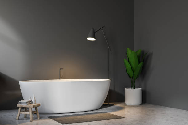 istock Gray bathroom corner, white tub and lamp 1043824988