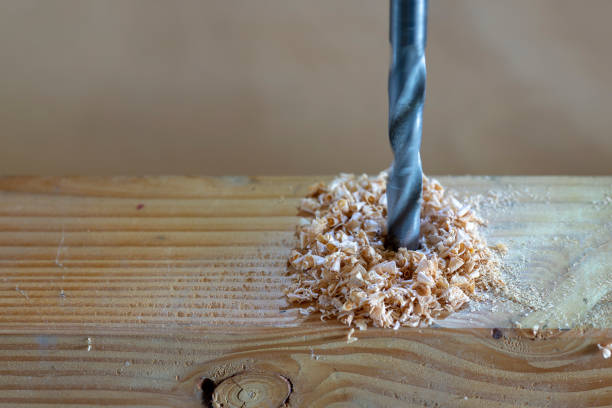 istock metal drill bit make holes in a wooden plank 1043829154