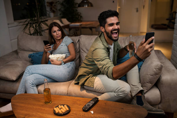 istock Young couple spend their evening at home using a smartphone 1043829726