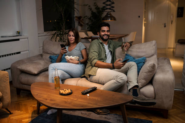 istock Young couple spend their evening at home using a smartphone 1043832224