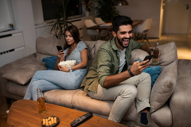 istock Young couple spend their evening at home using a smartphone 1043832398