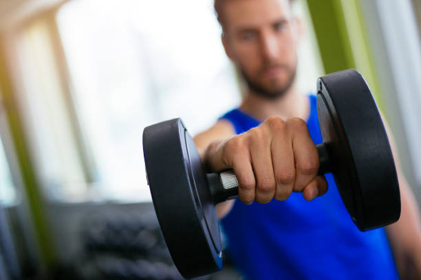 istock Man holding dumbbell in his hand 1043833078