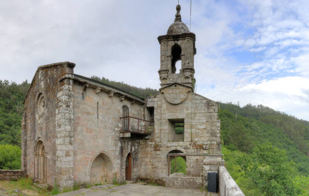 istock The ancient, stone-made, lost Caaveiro Monastery (Monasterio de Caaveiro) in the Fragas del Eume green and thick forest in Galicia, Spain 1043836988