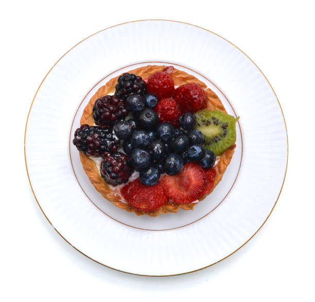 istock Fresh fruit tart in white plate on white 1043837182