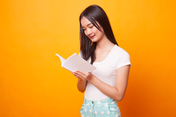 istock Young Asian woman read a book. 1043837664