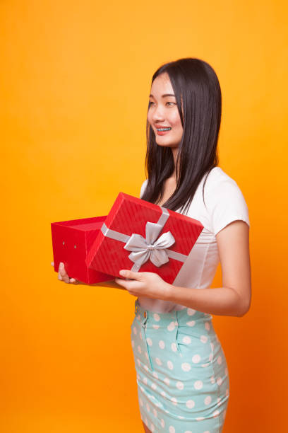 istock Young Asian woman open a gift box. 1043837898