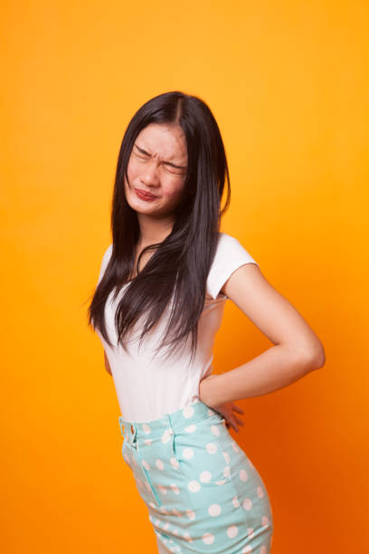 istock Young Asian woman got back pain. 1043838182