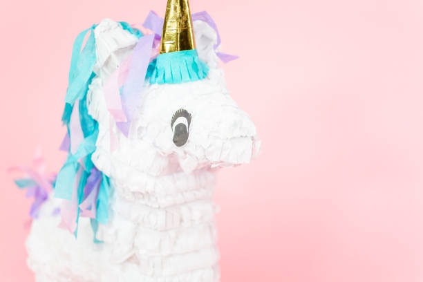istock Large unicorn pinata on pink background. 1043846174