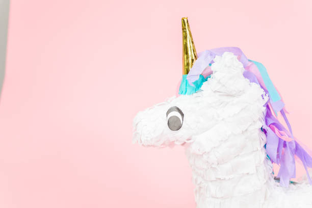 istock Large unicorn pinata on pink background. 1043846176