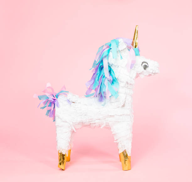 istock Large unicorn pinata on pink background. 1043846180
