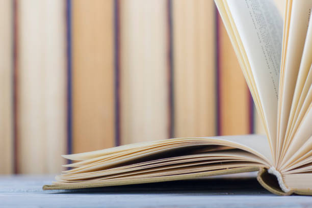 istock Open book, hardback books on wooden table. Back to school. Copy space 1043849480