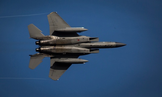 A U.S. Air Force F-15C Eagle aircraft fly through the skies above Joint Base Elmendorf-Richardson, Alaska.