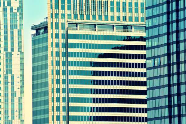 istock Modern office building on a clear sky background. Retro stylized colorful tonal filter effect 1043868464
