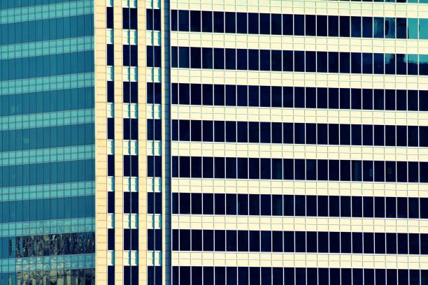 istock Modern office building on a clear sky background. Retro stylized colorful tonal filter effect 1043868704
