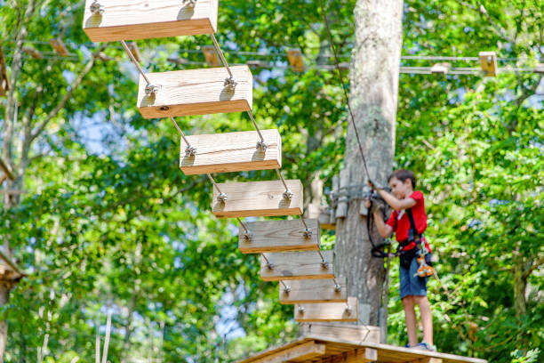 istock boy climbs in an aerial adventure park 1043868982