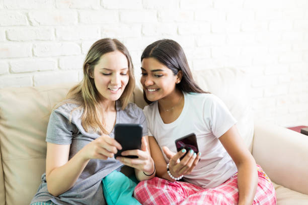 istock Friends Transferring Files From Smartphone To Another At Home 1043877706