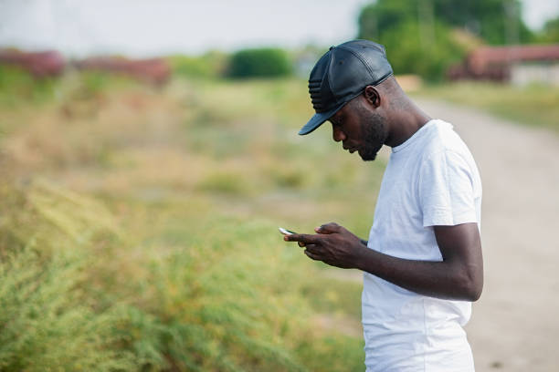 istock Hipster, a young man using a smartphone. African American guy holding a mobile smartphone 1043880760