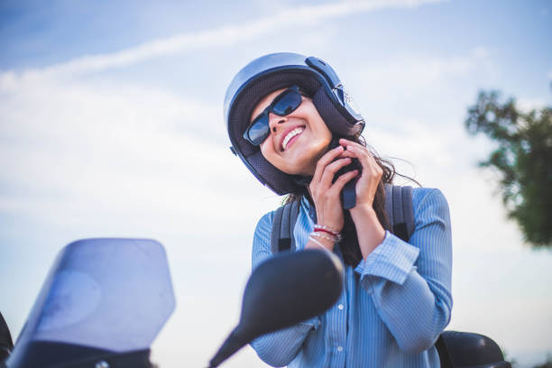 istock A woman sets a helmet and a scooter 1043905512