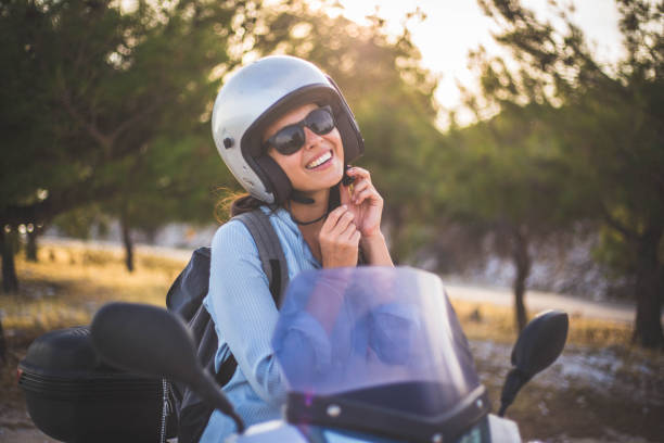 istock A woman sets a helmet and a scooter 1043905538