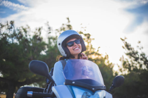 istock A woman sets a helmet and a scooter 1043905560