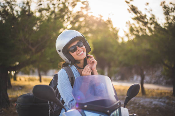 istock A woman and helmet on a scooter 1043905562