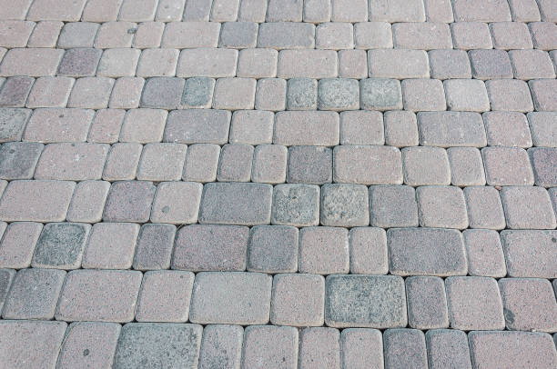 istock natural stone paving stone road from asphalt background summer 1043917878