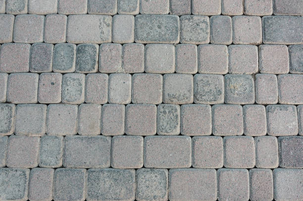 istock natural stone paving stone road from asphalt background summer 1043917882
