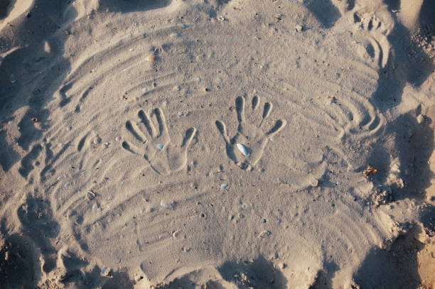 istock Seashore beach with sand, footprints in the sand, sand and seashells summer 1043923644