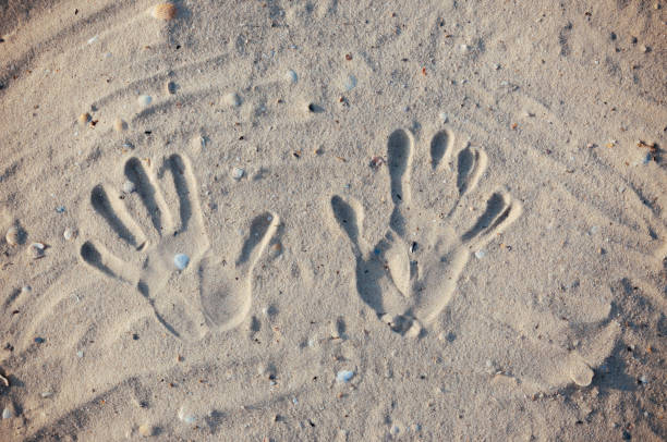 istock Seashore beach with sand, footprints in the sand, sand and seashells summer 1043923950